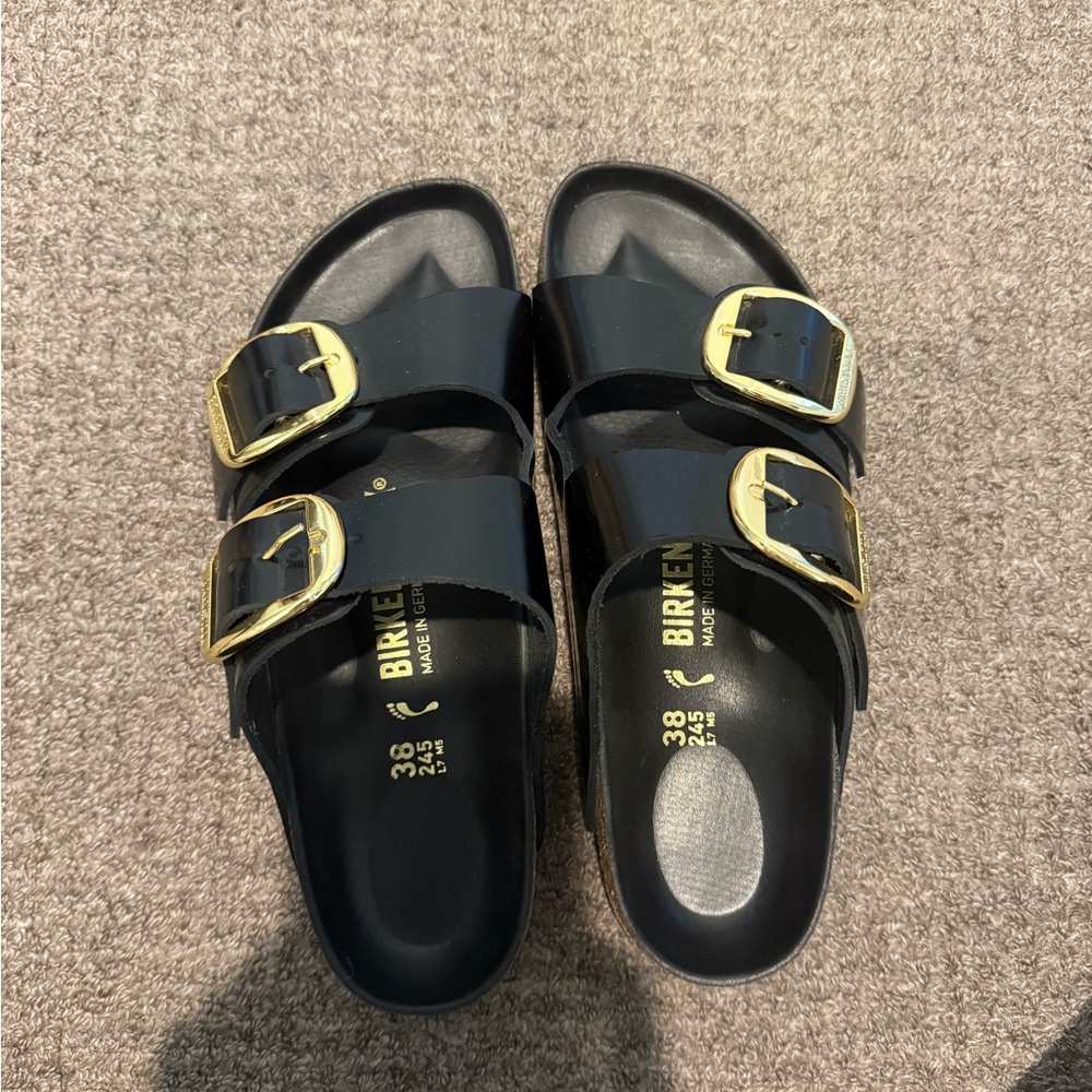 Birkenstock Glossy Black Sandals with Gold Accents